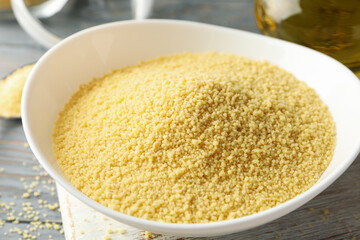 Concept of breakfast with couscous on gray wooden table