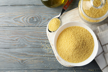 Concept of breakfast with couscous on gray wooden table