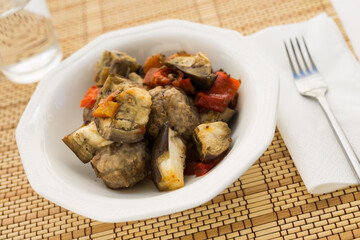 dish of vegetable stew. stewed eggplant, minced meat, carrots, peppers, onion squid