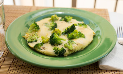 wholesome breakfast. omelet with broccoli on green plate