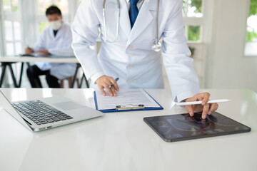 Doctor using digital tablet searching science research report. medical technology and health care...