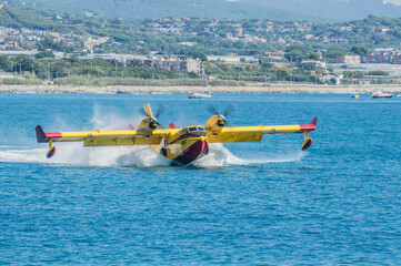 Barcelona, Spain; August 16, 2018: Old yellow fire fighters plane in action.  415