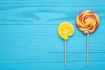 Colorful spiral lollipops on blue background. Candy.