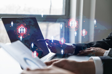 Man and woman working together on international business project. Blue infographic hologram of planet earth. World map. Multiexposure.