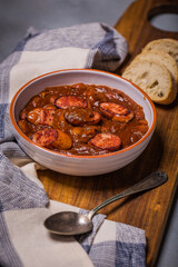 Polish breton beans with bacon, smoked sausages and onion, famous polish dish fasolka po bretonsku, baked beans in tomato sauce