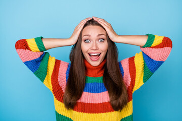 Portrait of astonished positive cheerful girl look good impressed lgbt information touch hands head scream wow omg wear rainbow style jumper isolated over blue color background