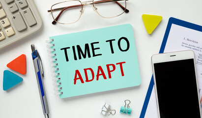 Business concept. Notebook with text TIME TO ADAPT