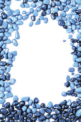 Fototapeta premium frame made of stones on a white background. beautiful blue pebbles in water drops. top view, flat lay