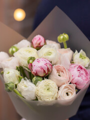 Flower shop. Beautiful bouquet of mixed flowers in woman hand. the work of the florist at a flower shop. Delicate Pastel color. Fresh cut flower.