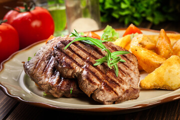 Succulent portions of grilled fillet mignon served with baked potatoes