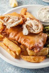 Fish in beer batter and chips with green pea and tartar sauce