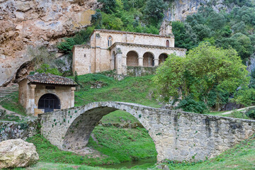 Fototapeta na wymiar Tobera town romanesque singular church and waterfalls in Burgos province, Spain.
