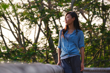 Beautiful Asian girl having a walk around the nature