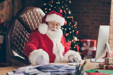 Profile side photo grey beard santa sit table work computer answer kids gift present wish list...
