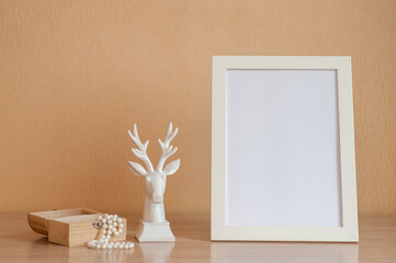 Photo frame and white deer on a neutral background