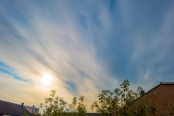 Clouds over a windy rainy city in sunlight in autumn, Almere, Flevoland, The Netherlands, October 13, 2020
