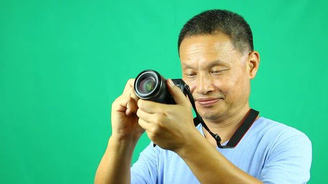 Tourist  taking a picture of view , with green background in studio  Chiangmai Thailand