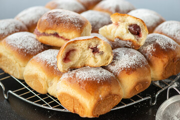 Sweet bread rolls with cherri filling and powdered sugar on top