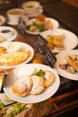 Vertical shot of different breakfast plates on sale at coffee shop display
