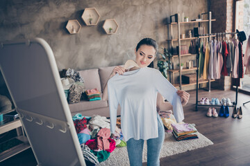 Portrait of her she nice attractive capricious girl looking at mirror trying sweater flattering...