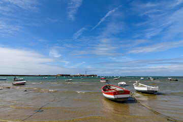 Fototapeta premium Small fishing boats by La Caleta beach in Cadiz, Andalusia, Spain