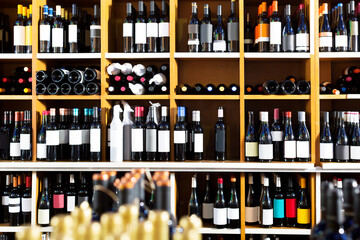 View on supermarket shelves with wide assortment of wine bottles