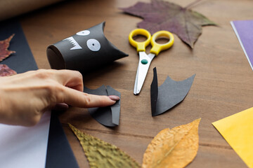 step by step instruction. Step 10 
Children's crafts for the holiday halloween. Paper garland decoration - scary funny black bat. Handmade from a toilet sleeve. Ideas for classes in school tutorial