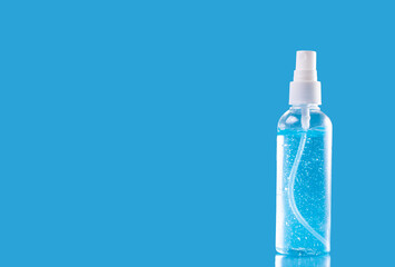 Bottle sanitizer gel alcohol desinfectant for hands in neutral background blue