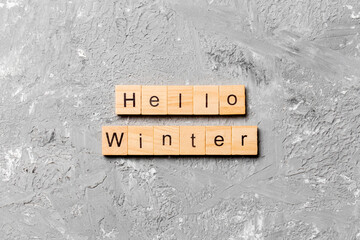 hello winter word written on wood block. hello winter text on cement table for your desing, concept