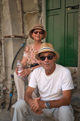 Senior couple tourists couple on stairs. Riomaggiore,Cinque terre, Italy.