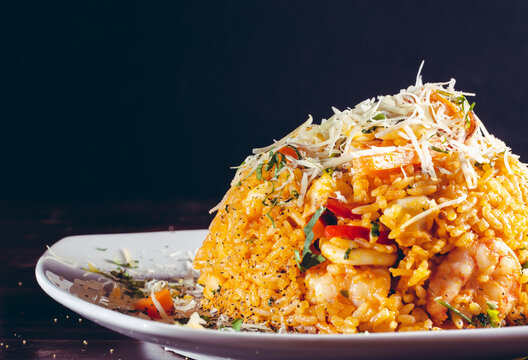 Arroz con mariscos rice with seafood prawns typical peruvian food in wood table