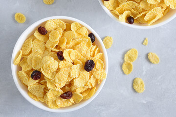 Cornflakes with dried cranberries for Breakfast on a white plate