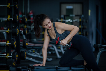Portrait beauty sport woman wear sportwear posing under exercise with fitness equipment at gym ,she exercise for strong ,make muscle and good healthy.
