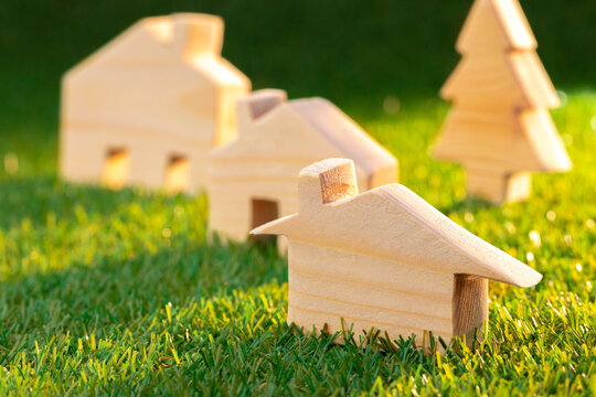Wooden toy house miniature on grass close up