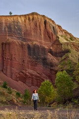 Redhead curly lady at sunset inside an extinct volcano