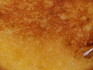 The texture of wheat bread toasted in butter.