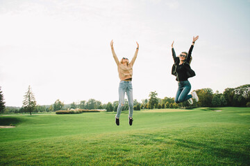 Fototapeta na wymiar Happy young women on green meadow