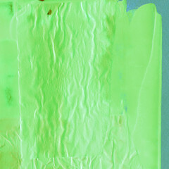 Green torn paper collage close-up. Texture made from various paper and cardboard parts. Damaged old paper background. Vintage blank wallpaper. Material design backdrop.