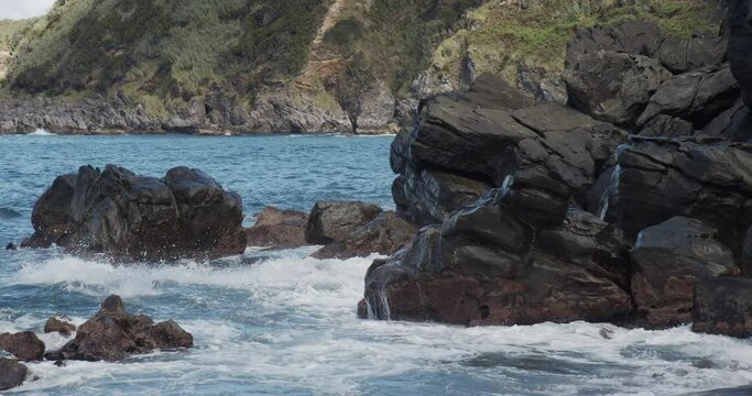 Slow motion sea waves crachin onto rocks at Praia dos Moinhos, S&atilde;o Miguel, Azores Portugal
