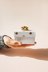 A person holding a box with a gift