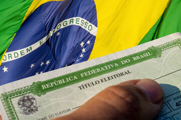 detail of the title of Brazilian voter and flag of Brazil. 2022 elections in Brazil(Título de...