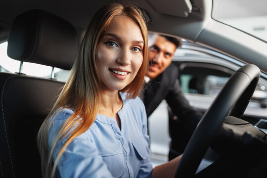 Happy Woman New Car Owner Sitting In Driver Seat