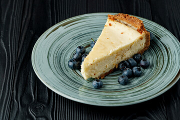 Piece of classic cheesecake on green plate