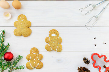 Gingerbread men on a wooden table. Horizontal orientation, top view.