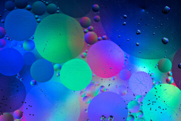Space with colored planets (oil droplets in water)
