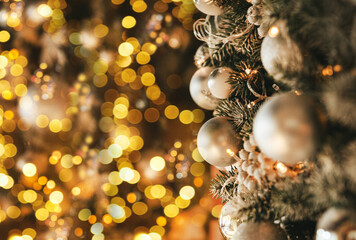 Obraz na płótnie Canvas Christmas decoration in a golden style with bokeh and copy space. Merry Christmas and Happy Holidays.