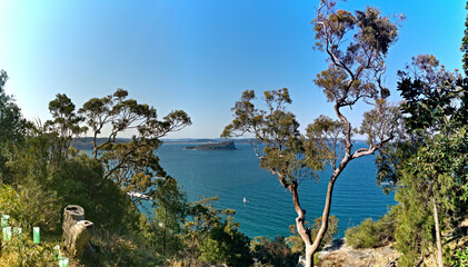 Fototapeta na wymiar Beautiful afternoon view of ocean, island and deep blue sky from top of a lookout, West Head Lookout, Ku-ring-gai Chase National Park, Sydney, New South Wales, Australia 