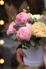 Floral bunch in round box. Fresh delicate bouquet of beautiful Mixed flowers. Excellent garden flowers in the arrangement , the work of a professional florist. Gift box