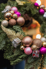 Christmas bouquet. Red flower of carnation, cone and cotton with Christmas tree branches. New year bouquet flowers and fir branches in a basket. Christmas wreath