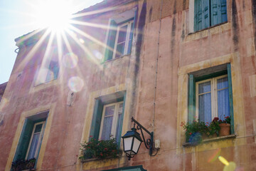 Sunrays coming out of an old building facade